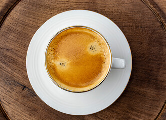 cup of espresso on wooden background top view