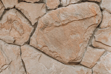 Old ancient stone wall close up. Large stones background with organic detailed texture.