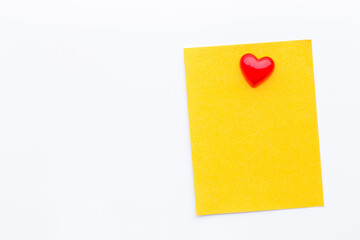 Abstract empty sticky note with heart magnet on white board. valentine greeting card message.