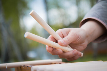 Bashe game close up, hand with two sticks