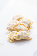 Fototapeta na wymiar Pierogi or Vareniki, raw frozen dumplings isolated on white background with clipping path
