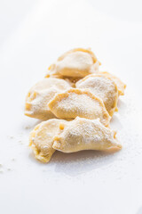 Pierogi or Vareniki, raw frozen dumplings isolated on white background with clipping path