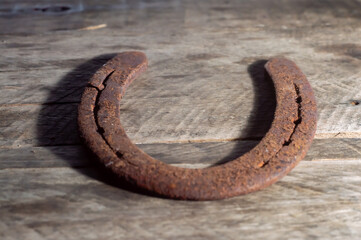 Horse horseshoe with wooden background and natural light,copy space in parts of the image,farm...