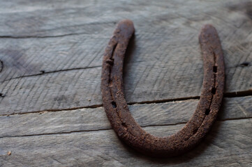 Horse horseshoe with wooden background and natural light,copy space in parts of the image,farm...
