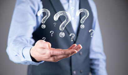 Businessman hand hold interface question marks