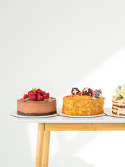 Three cakes: with strawberries and chocolate, with honey and with fruits