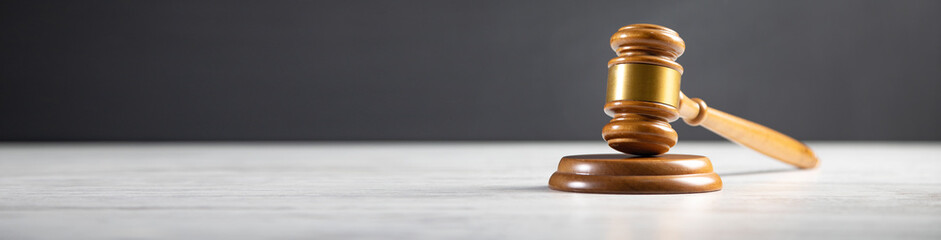 Judge's gavel on white table