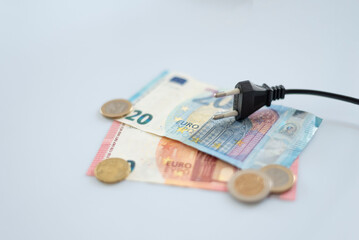 Black electric cap on euro banknotes. Increase in the cost of electricity for residential customers...