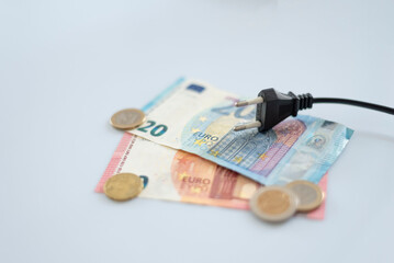 Black electric cap on euro banknotes. Increase in the cost of electricity for residential customers and business users. Payment of electricity bills. Increasing the concept of electricity prices.