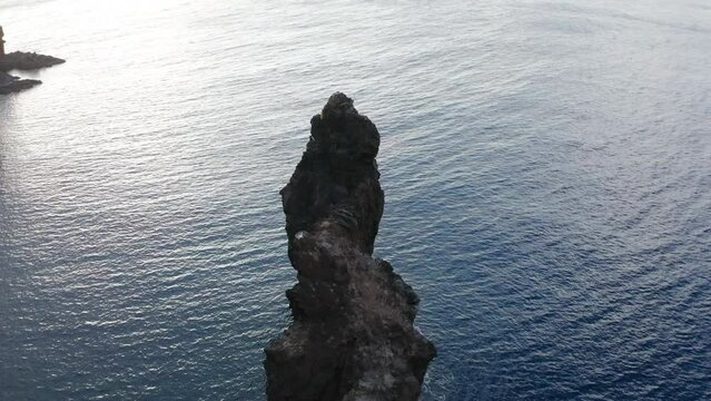 Aerial arc shot around famous rock formation El Roque de La Bonanza