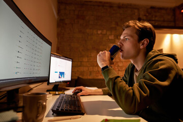 Male trader watch on stock data on computer online