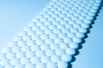 Medical Pills Lined up Neatly in a Blue Background