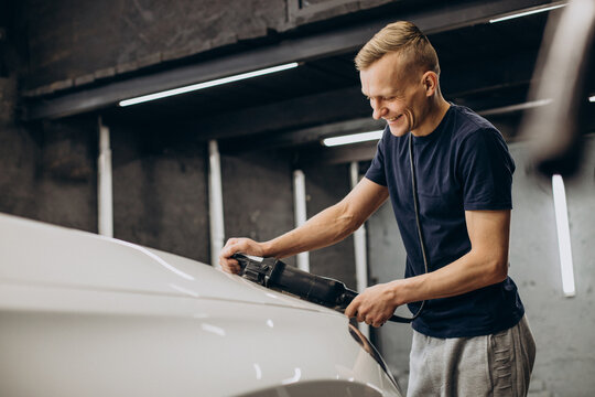 Man Polishing Car With Orbital Applicator