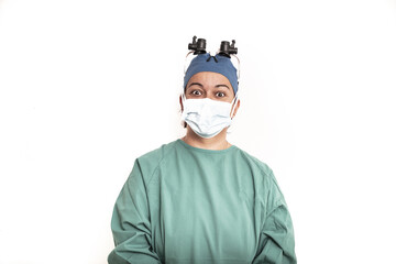 Sterile femal nurse or surgeon wearing a sterile green suit or gown waiting on the operation theater isolated.