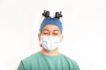 Sterile femal nurse or surgeon wearing a sterile green suit or gown waiting on the operation theater isolated.