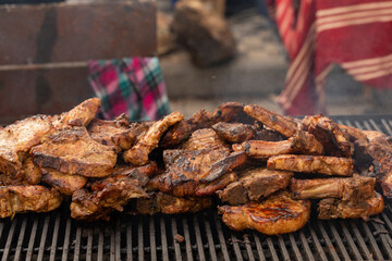Roasting meat on the grill. Cooking fast food on the street.