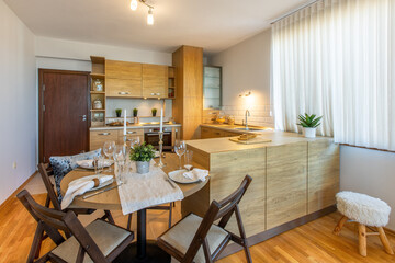 Dining table with table set in modern dining room interior design concept. Table served for dinner in living room