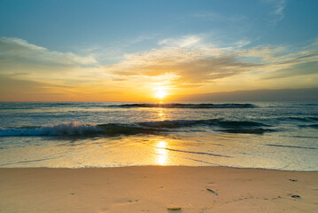 Beautiful beach sunset Water wave on sandy beach