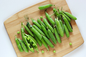 Bunch of green pea pods on the table.