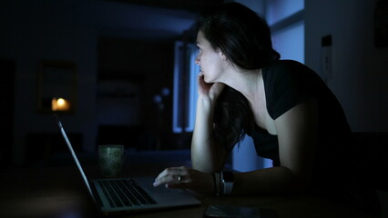 Woman hearing a noise at home turning head observing surroundings