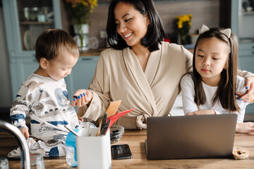 Asian family using laptop while spending time together