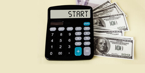 Start text on calculator display with dollars banknotes on white background