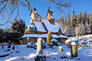 Old wooden stave church Vang (Wang) in winter. It was transferred from Norway and re-erected in...