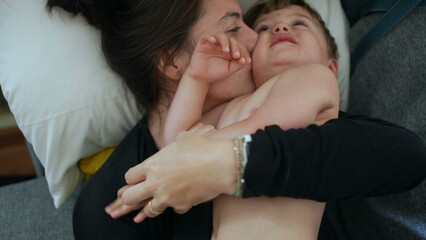 Playful mother and child in sofa together mom and kid playing