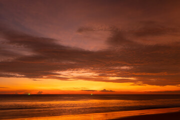 Naklejka na ściany i meble Sunset on beach sea beautiful in nature