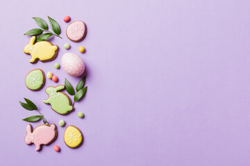 holiday preparation Multi colors Easter eggs with cookies on colored background . Pastel color Easter eggs. holiday concept with copy space
