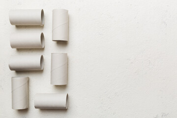 Flat lay composition with empty toilet paper rolls and space for text on color background. Recyclable paper tube with metal plug end made of kraft paper or cardboard