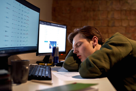Tired male trader or broker sleeping at desk