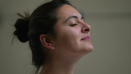 Fototapeta premium Meditative woman eyes closed taking a deep breath out contemplative person