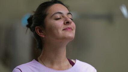 Meditative woman eyes closed taking a deep breath out contemplative person