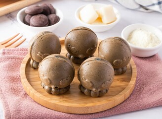 Original Bamboo Charcoal Chicken Cake teddy bear shape in wooden plate on marble background