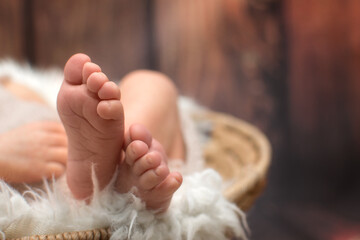 Close up view on litttle newborn baby foot. Detail of cute kid legs. Parenthood or motherhood concept with copy space.