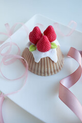 romantic handmade candle made of natural soy wax in the form of strawberry cake 