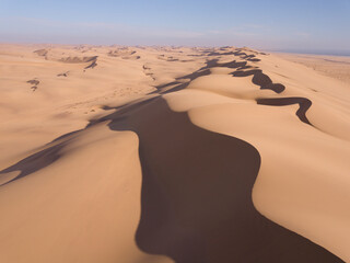 Aerial over huge sand dunes near the coastline