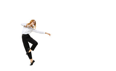Full-length portrait of young blonde girl in white shirt and black trousers moves isolated on white background. Finance, ballet, art, business, beauty concept.