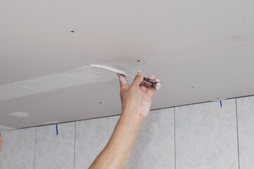 masonry worker make concrete wall by cement block and plaster at construction site