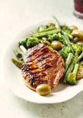 Grilled Turkey Breast with oven baked potatoes and broccoli. Close up.