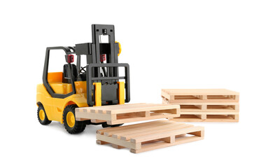 Toy forklift truck with wooden pallets on white background