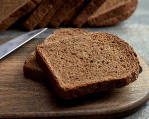 Fototapeta na wymiar Sliced rye bread on a wooden board