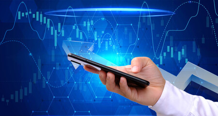 Hologram of a forex chart sketch and a woman carrying and using a mobile device are seen in a double exposure. Concept of a financial market.