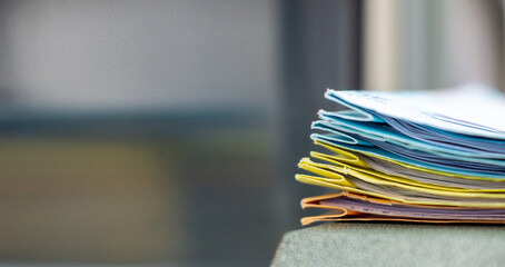 Colorful document folders are arranged vertically on the office desk.