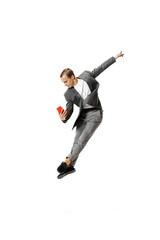 Young man in gray business suit dancing, jumping, flying isolated on white background. Business, art, motion, action, creativity, inspiration concept.