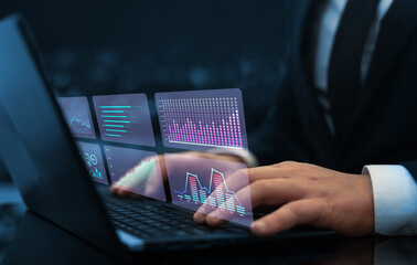 Businessman analysing economic growth graph financial data on digital screen. HUD charts diagram,statistics and data analytics.