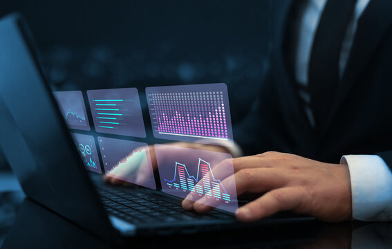 Businessman analysing economic growth graph financial data on digital screen. HUD charts diagram,statistics and data analytics. - Powered by Adobe