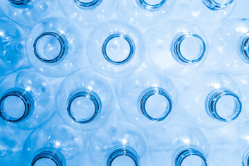 Bottling plant - Plastic bottles from above. Abstract background of plastic bottles. Selective focus