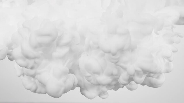 Clouds of white paint in the water look like cream or milk.